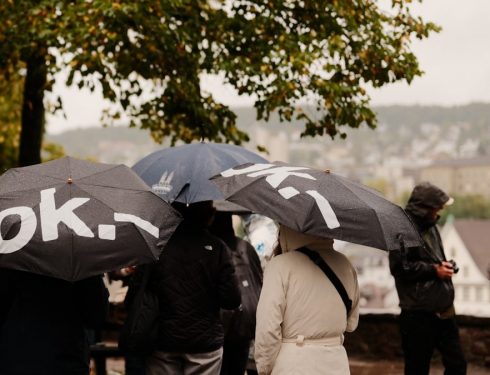 People holding umbrellas in the rain